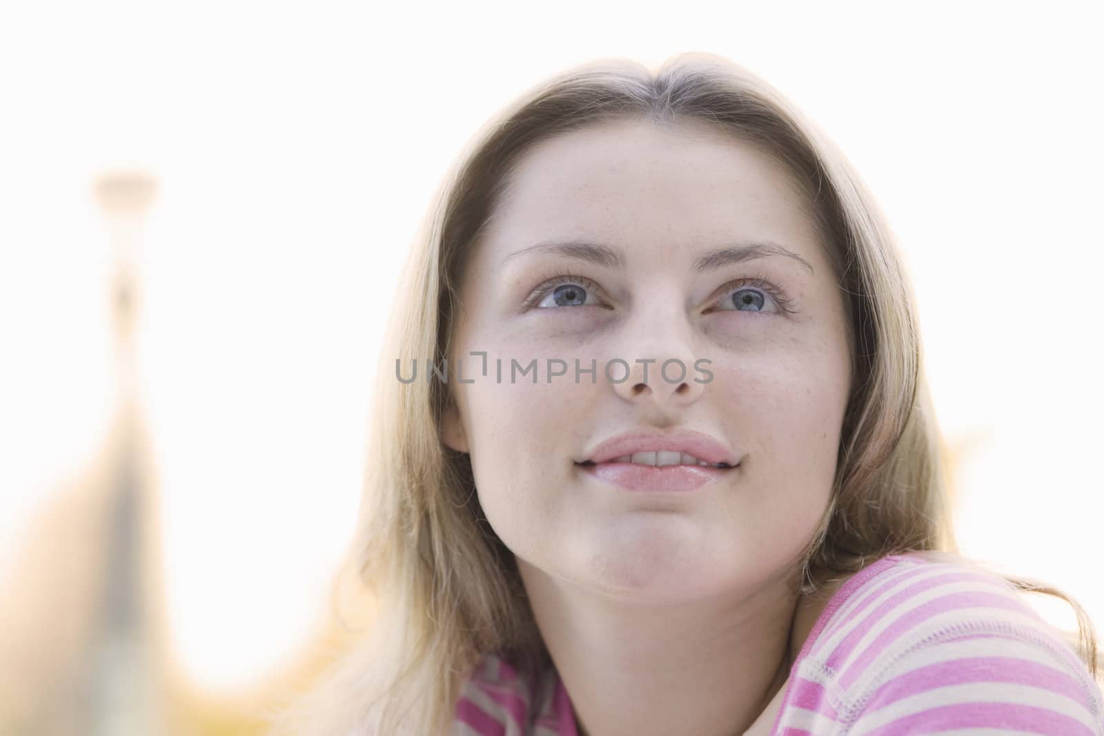 Portrait of a Pretty Blond Teen Girl Looking Up To The Sky