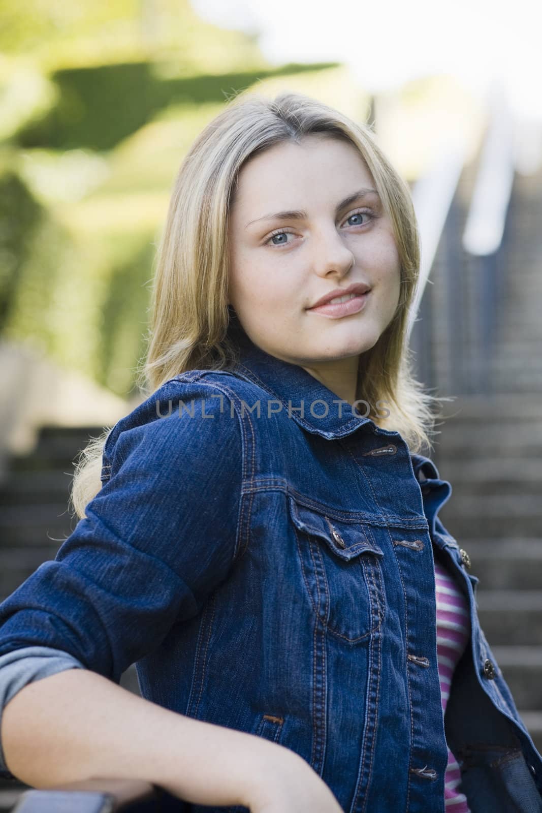 Pretty Blonde Teen Girl Standing on a Stairway Outdoors