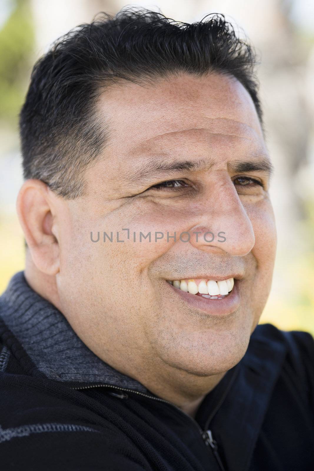 Portrait of a Smiling Overweight Man in Sweater in a Park