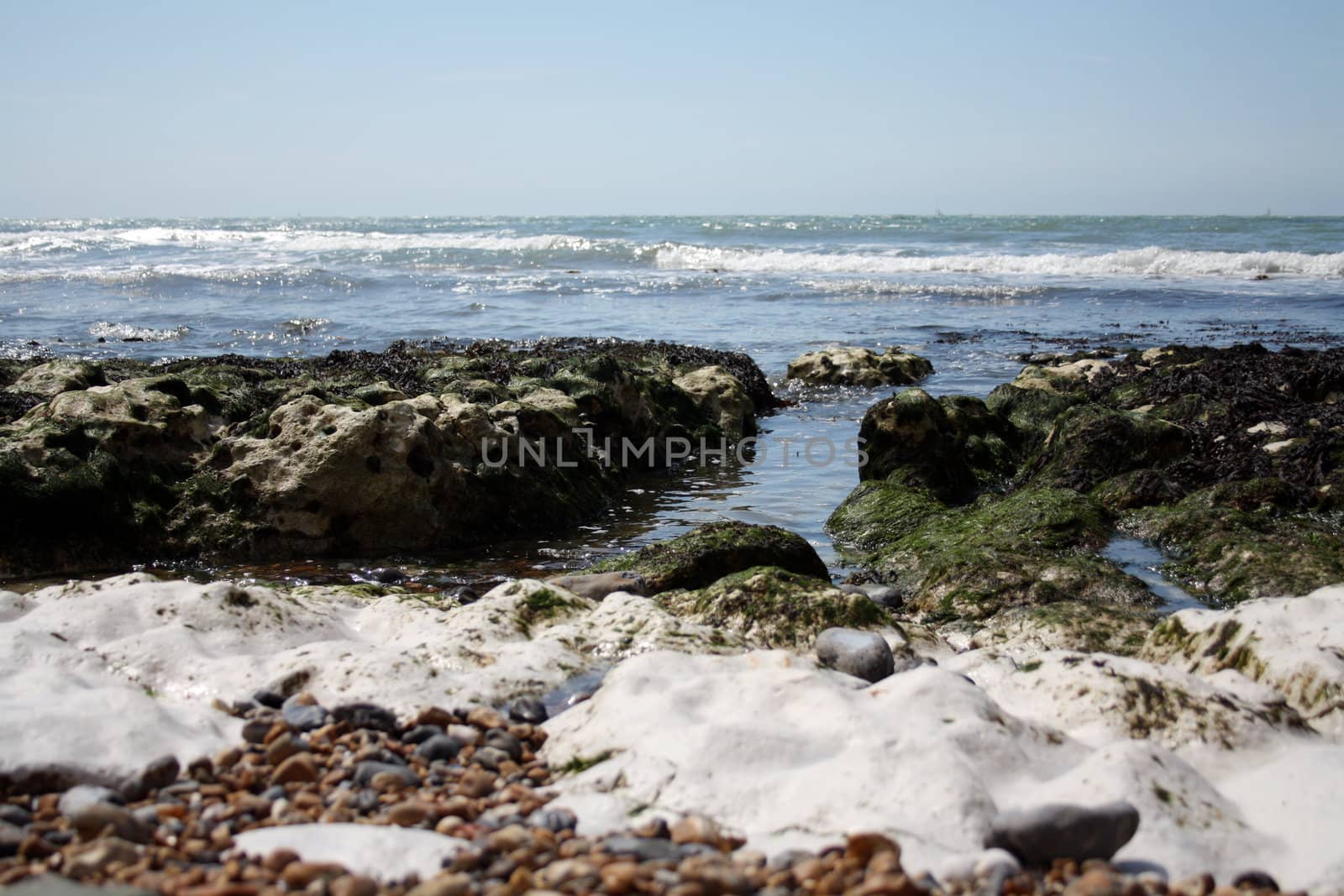 Many kind of rocks and pebbles appears when tide is low close to cliffs in La Marina at Brighton.