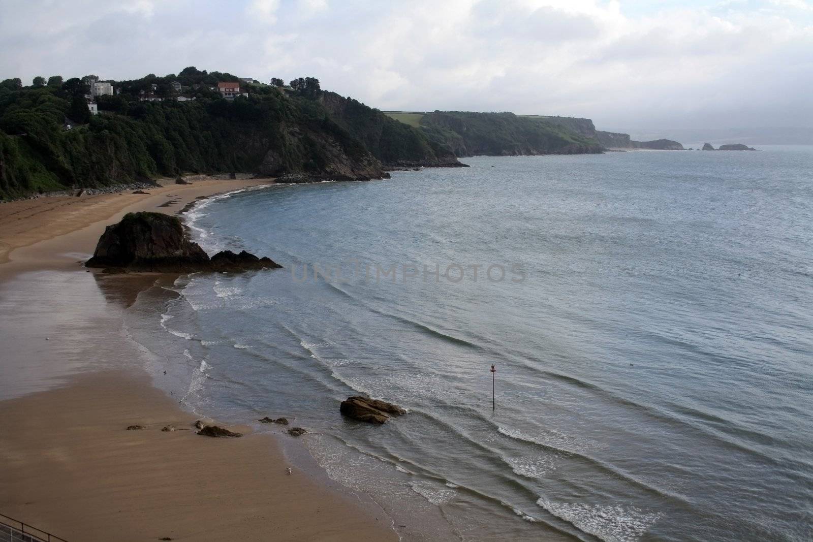 North Beach at the sunset of a summer rainy day in Tenby, Wales.