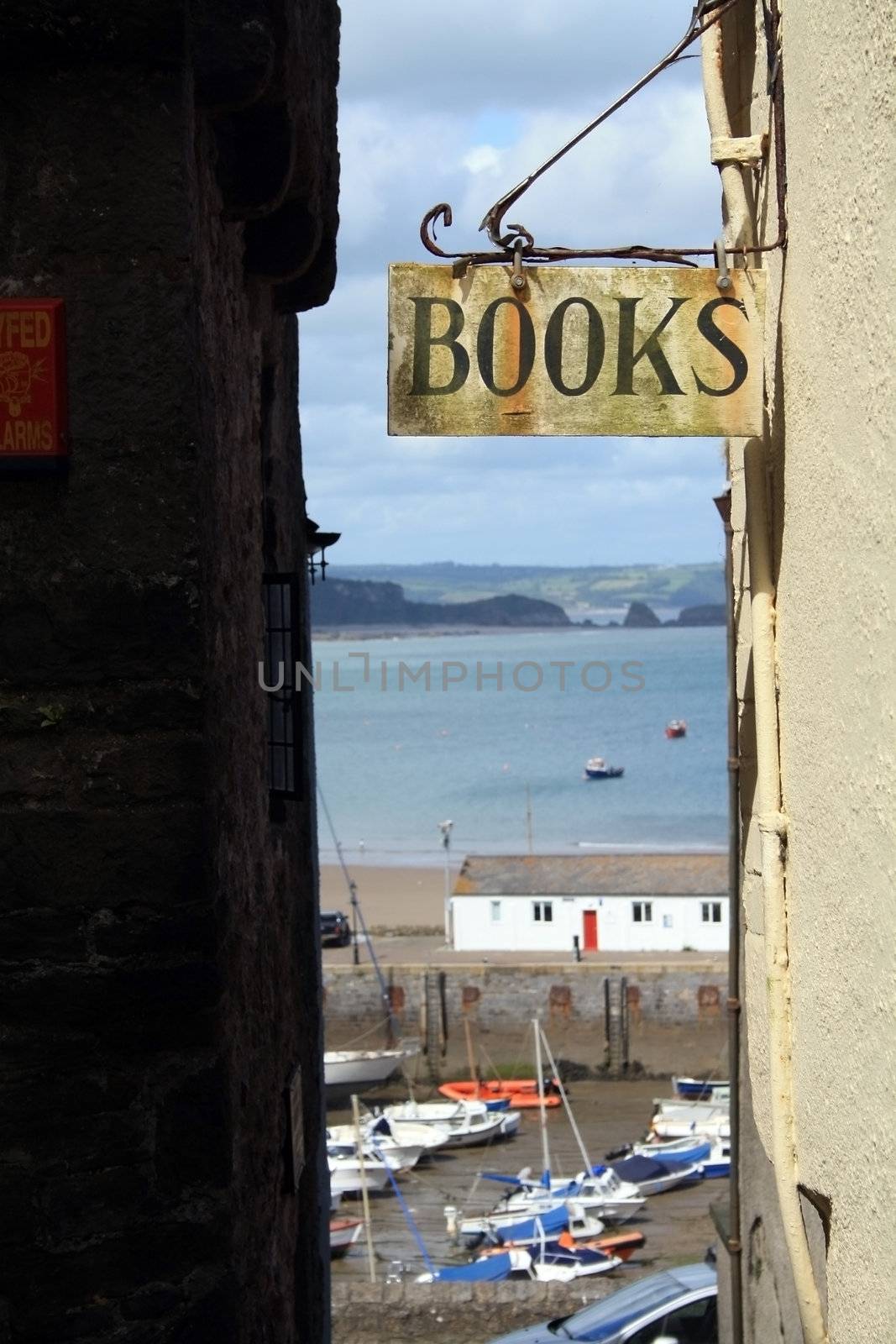 Library sign on a narrow street in Tenby, Wales.