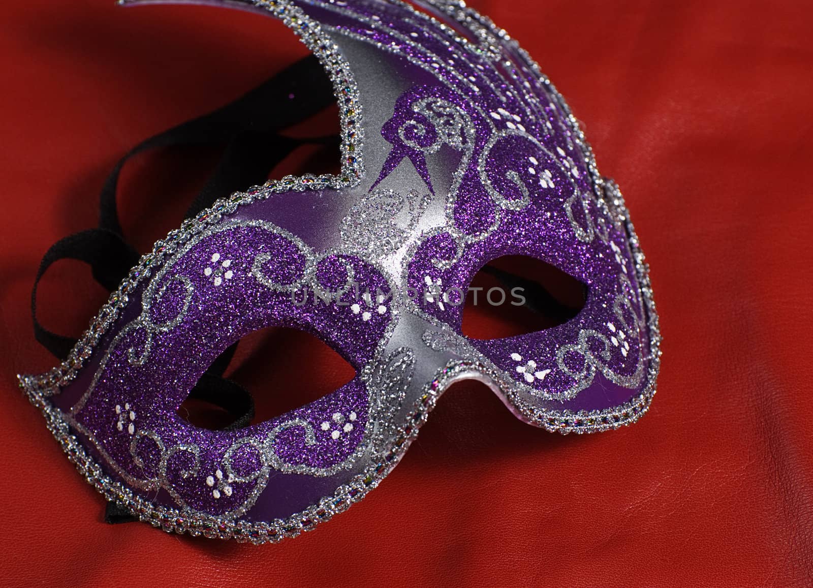 A blue mask shot against a red background