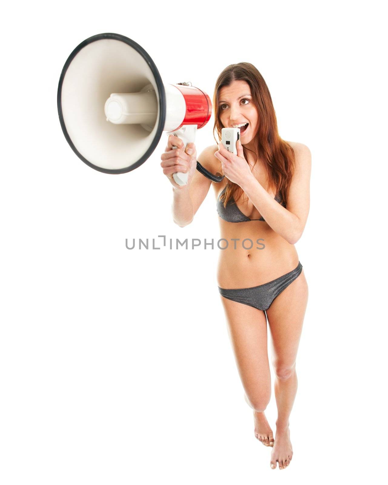 Beautiful  girl in bikini shouting into megaphone. Isolated on white