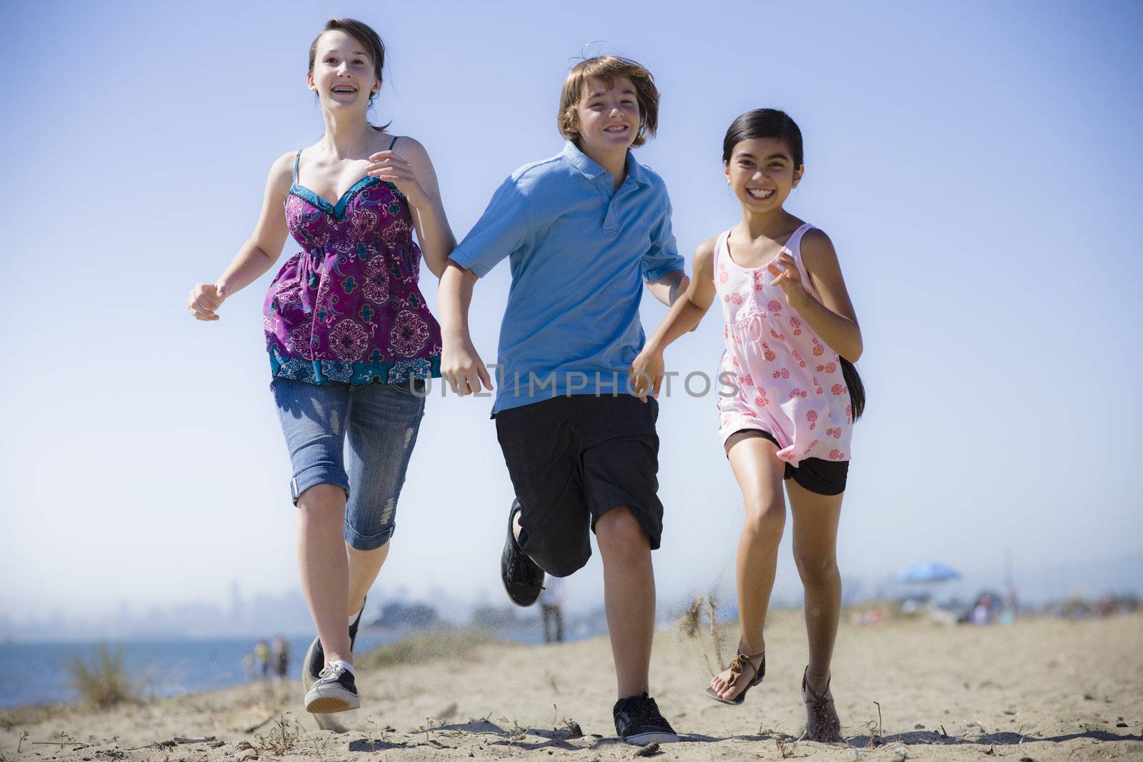 Group of Three Kids Running on the Beach