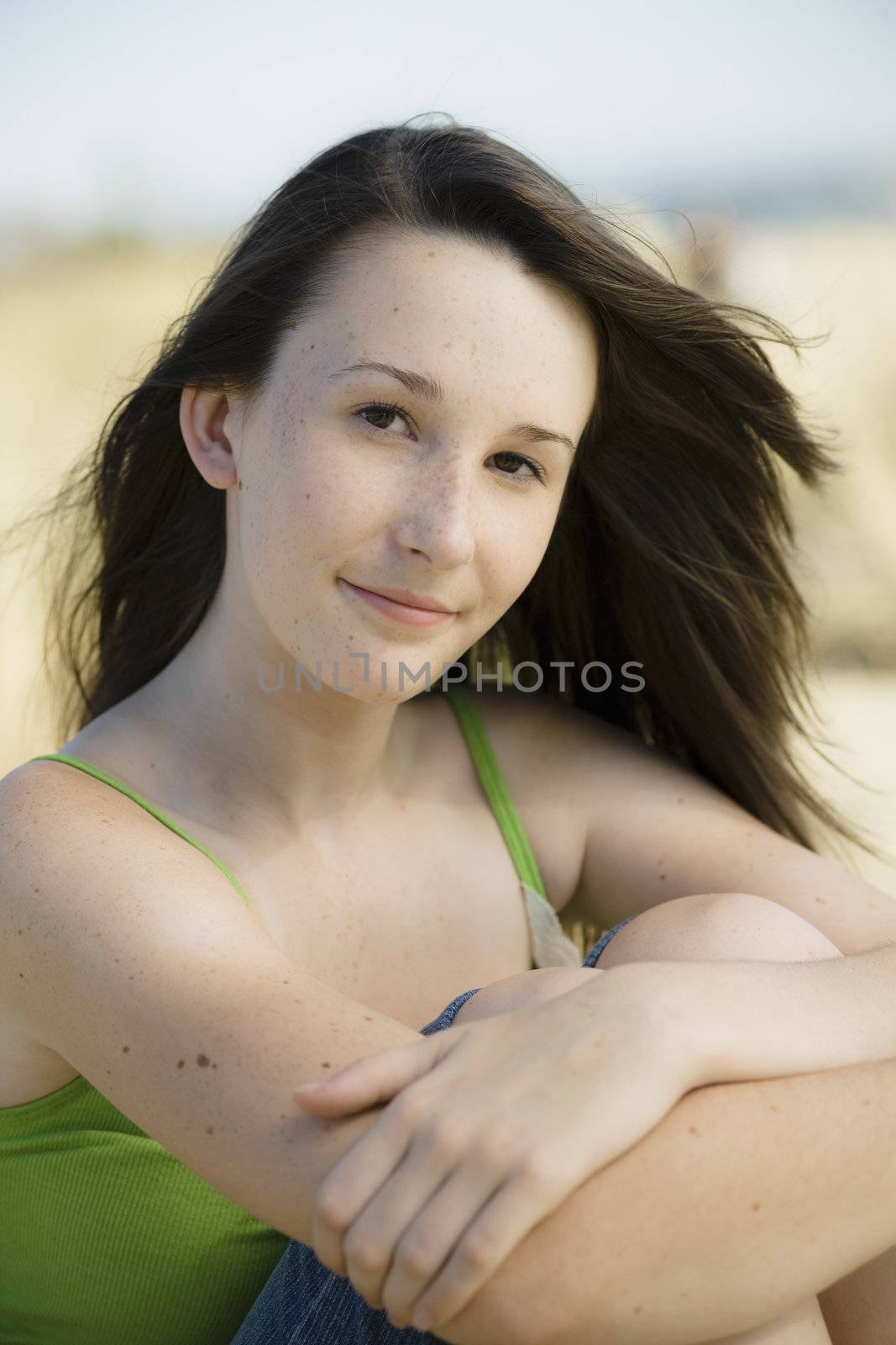 Portrait of Teenage Girl sitting at the Beach