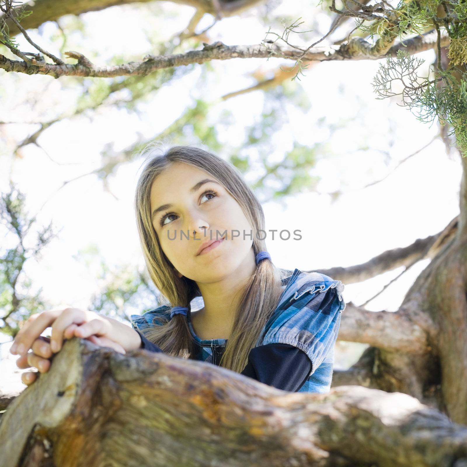 Portrait of Smiling Tween Girl Standing in Tree