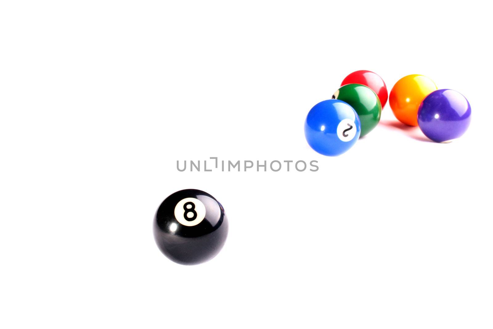 Billiard spheres on a white background, ahead a black sphere with number 8.