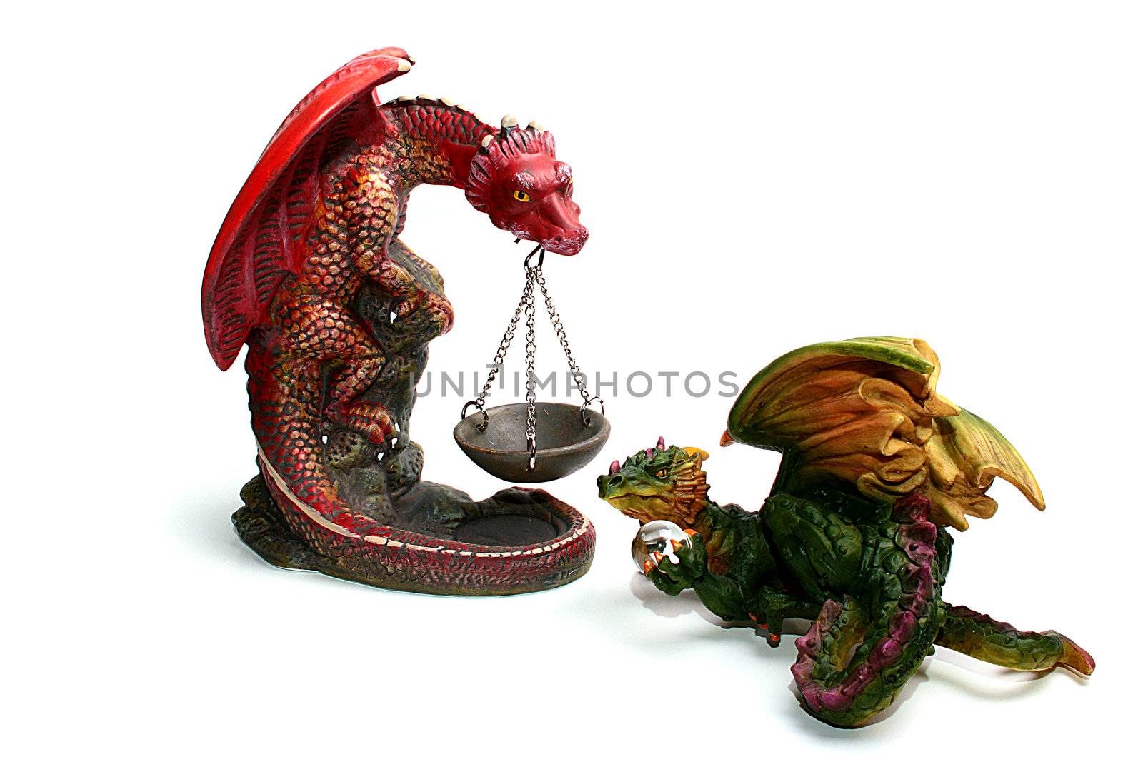 Two ceramic dragons, one holds a support for fire, the second holds a magic transparent sphere.