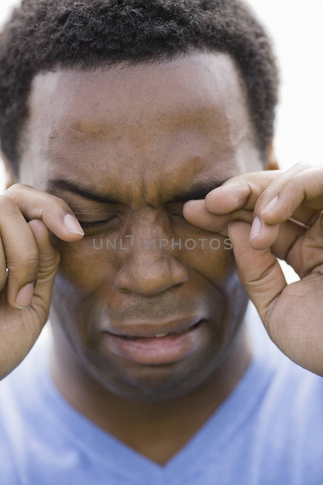 Portrait of Crying African American Male in Blue V-Neck T-Shirt