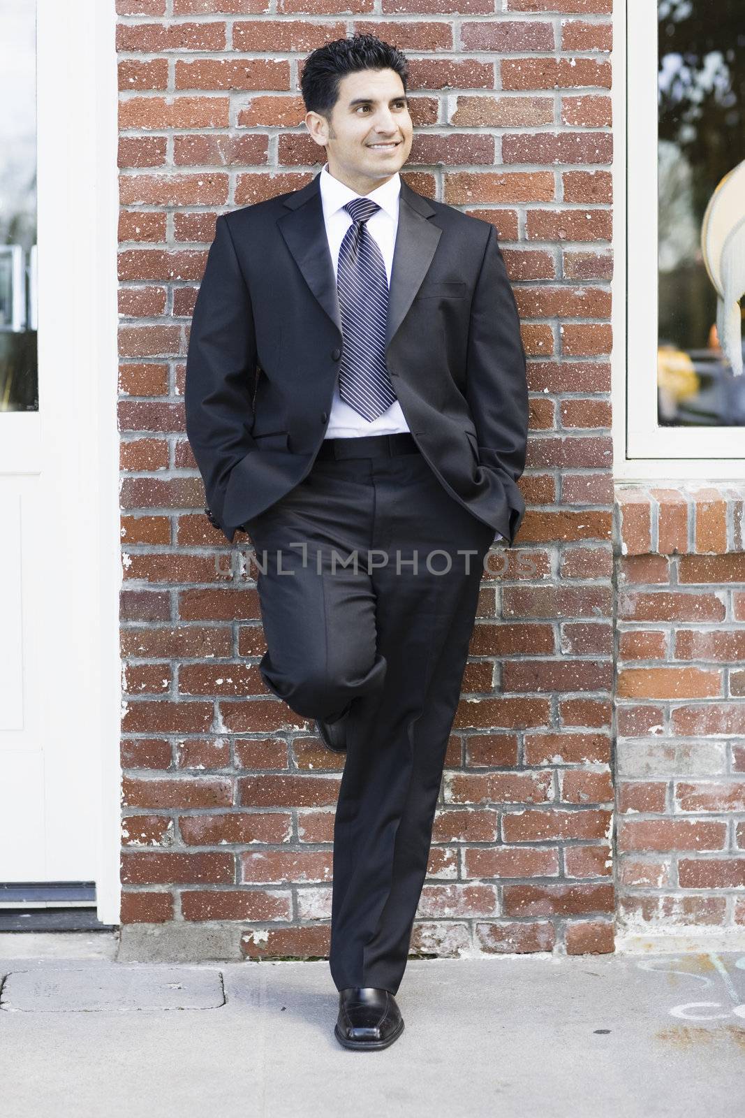 Smiling Man Wearing a Black Suit and Tie