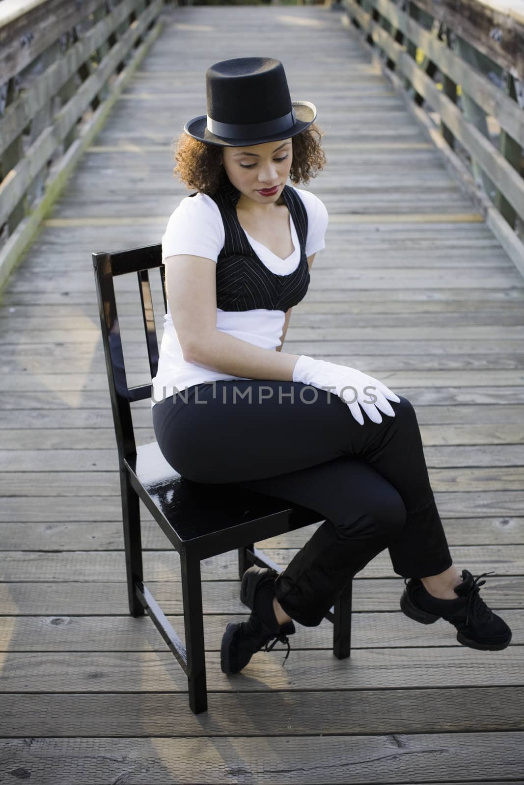 Jazz Dancer Sitting on Chair on Bridge