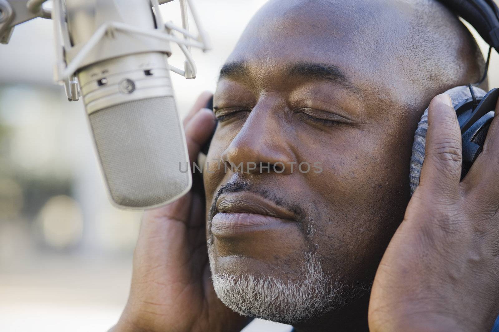 African American Man with Eyes Shut in Front of Microphone