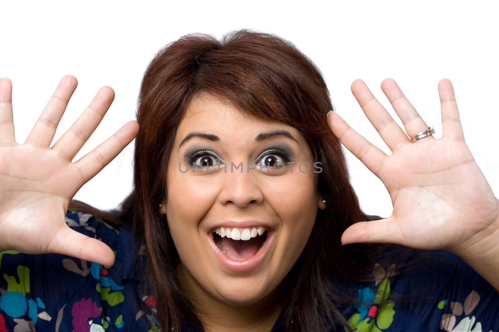 This young hispanic woman looks totally and completely surprised with her hands up in the air.