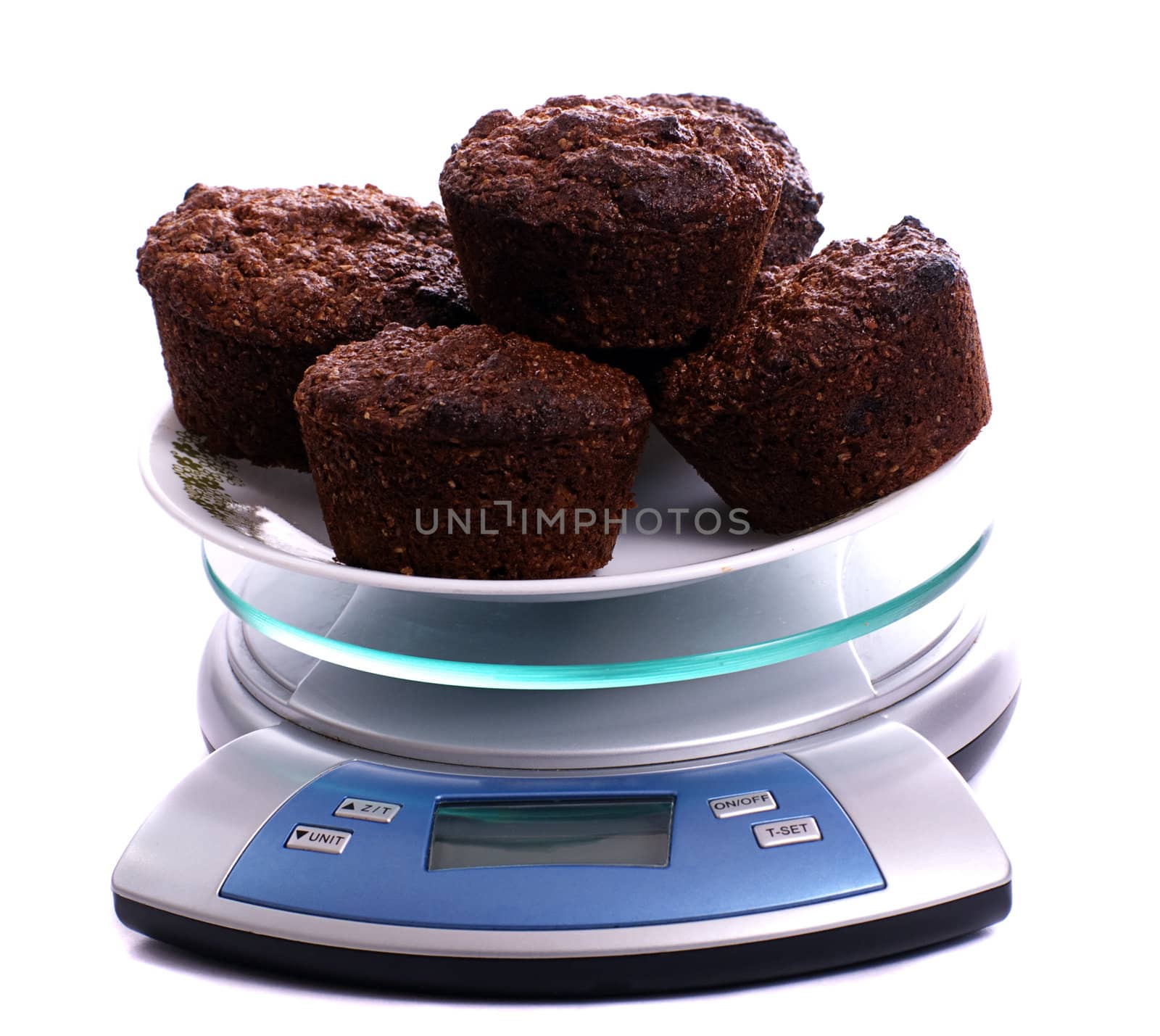 A plate of bran muffins on a small scale, isolated against a white background