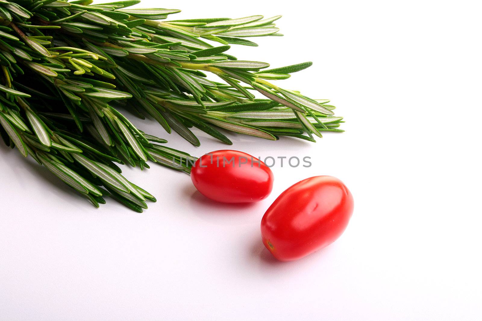 Two small red tomatoes and saffron branch.