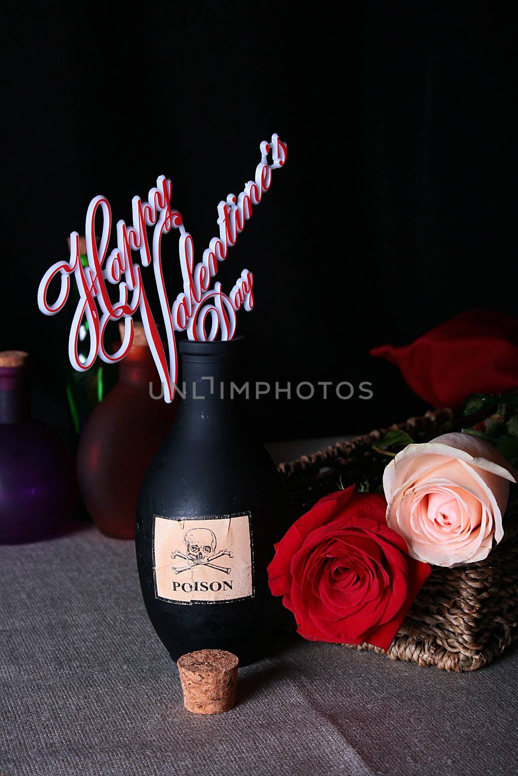 Bottle from black glass with poison against two roses. Happy Valentine's Day.