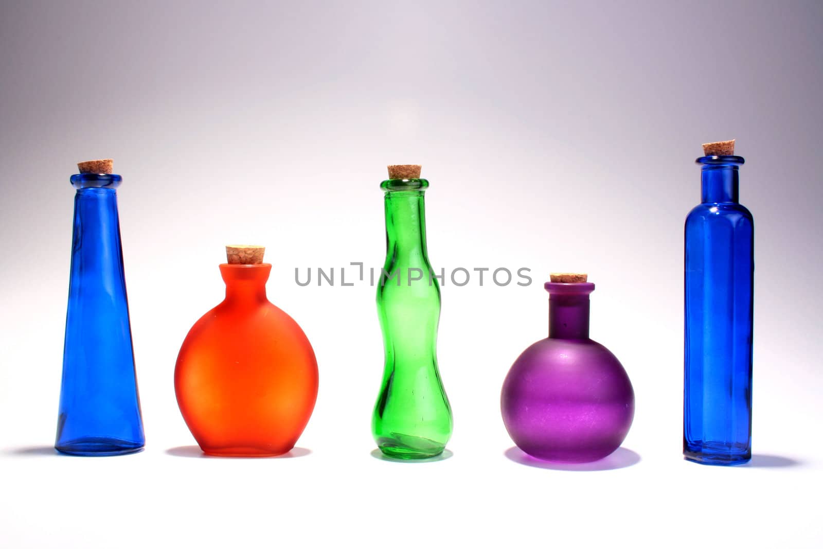 Set of bottles from colour glass with stoppers from a pith tree. A set for storage of female perfumery.