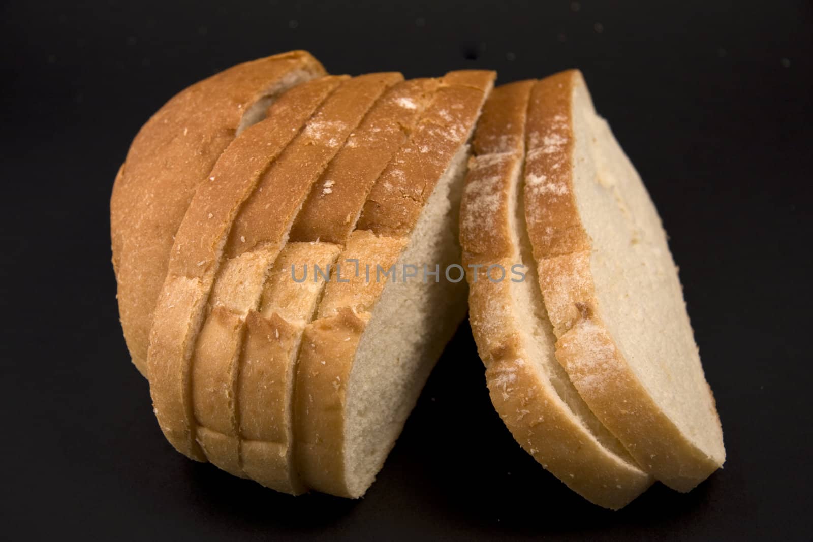 Sample a piece of sliced bread on a black background.
