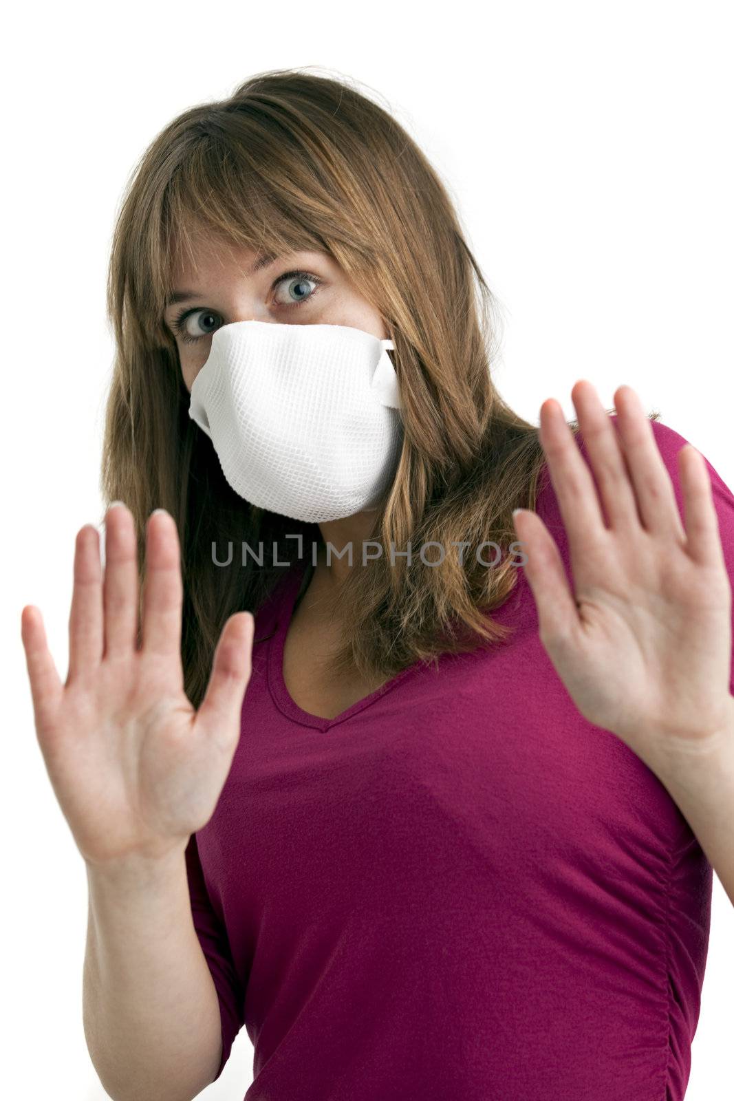scared young woman wearing a protective mask to protect her from swine flu by bernjuer