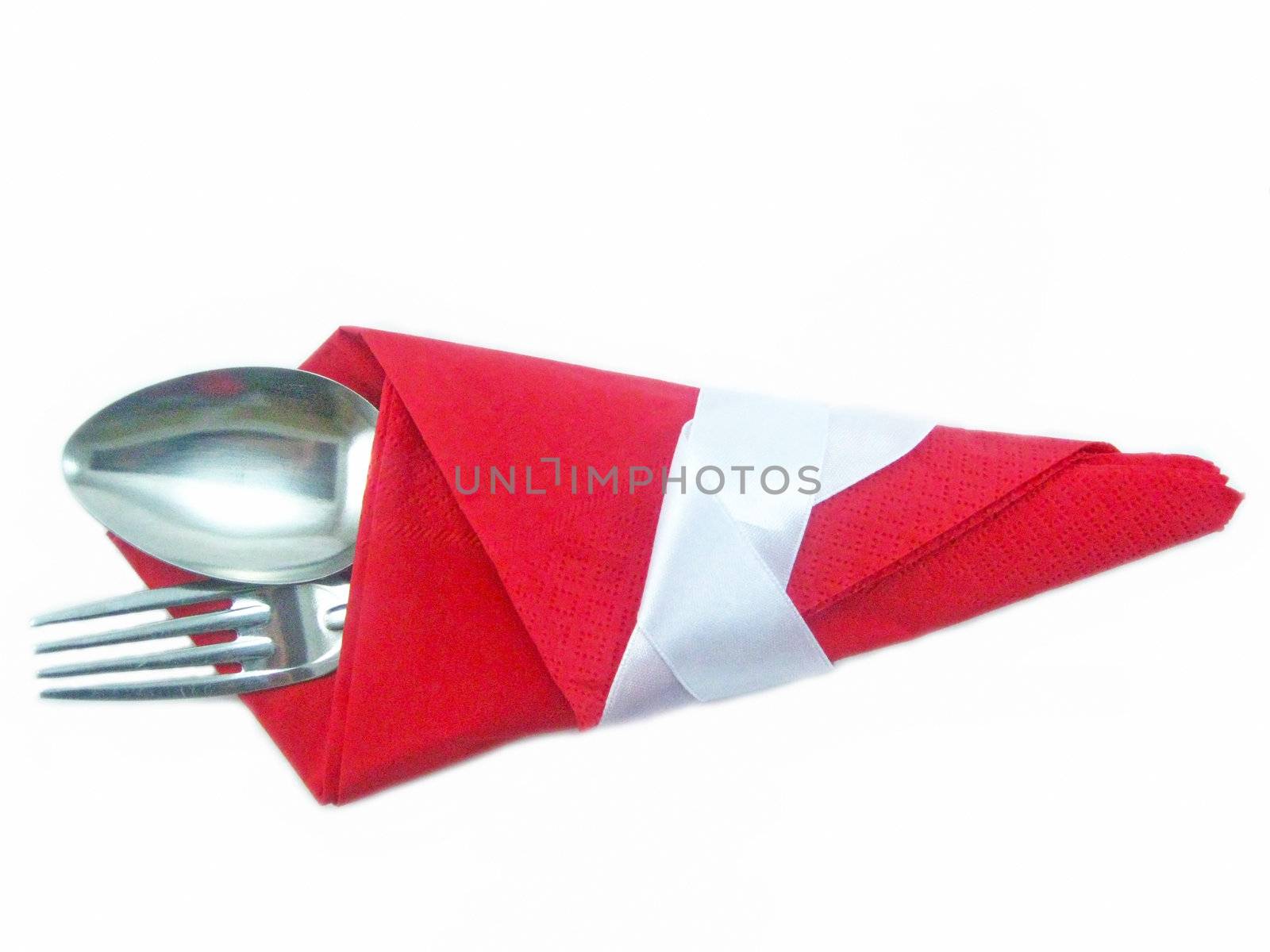 Spoon and plug in a red napkin