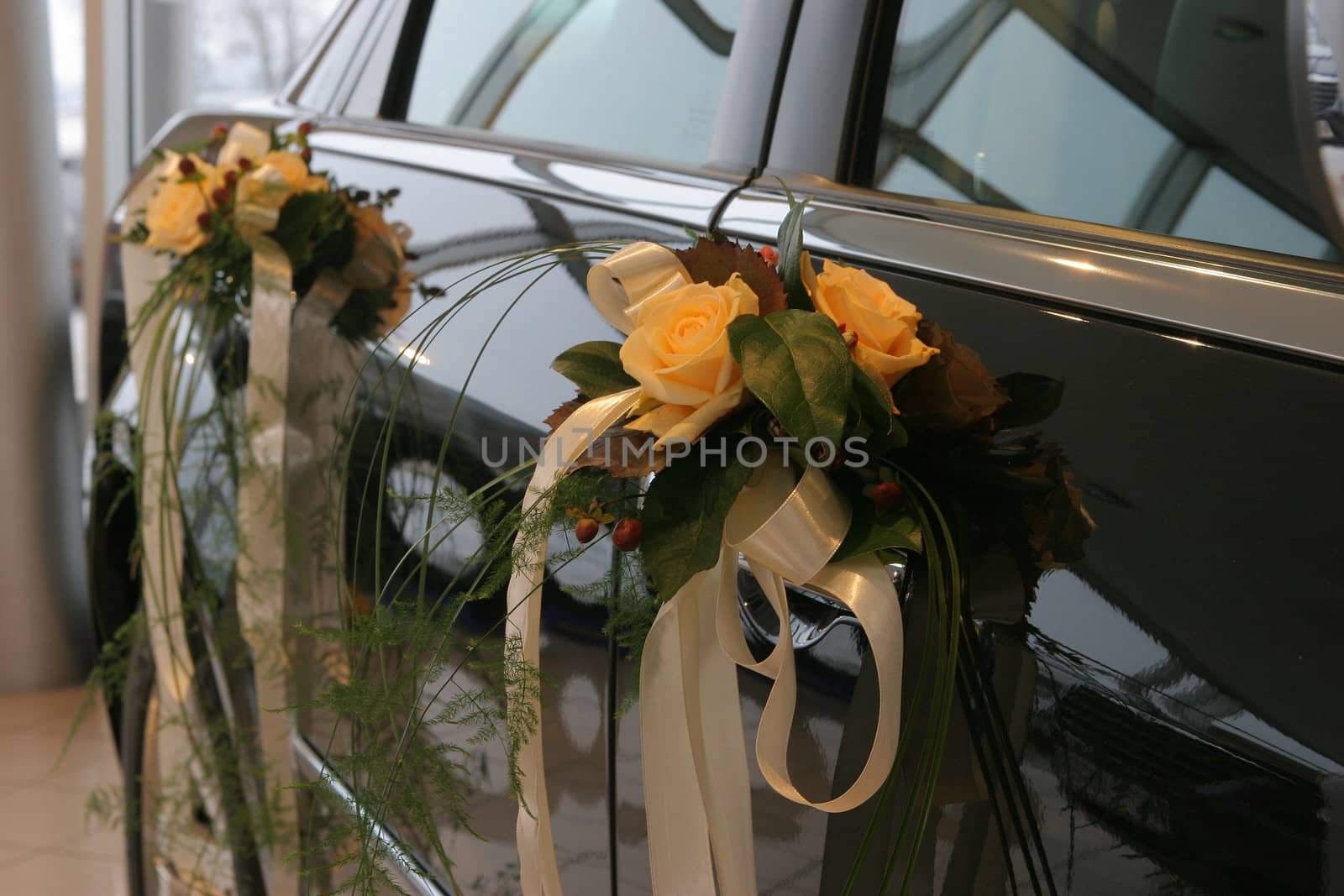Two bouquets fixed to car doors.