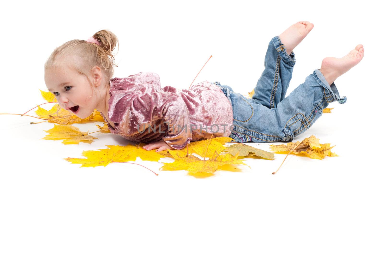 Shot of toddler playing with muple leaves in studio