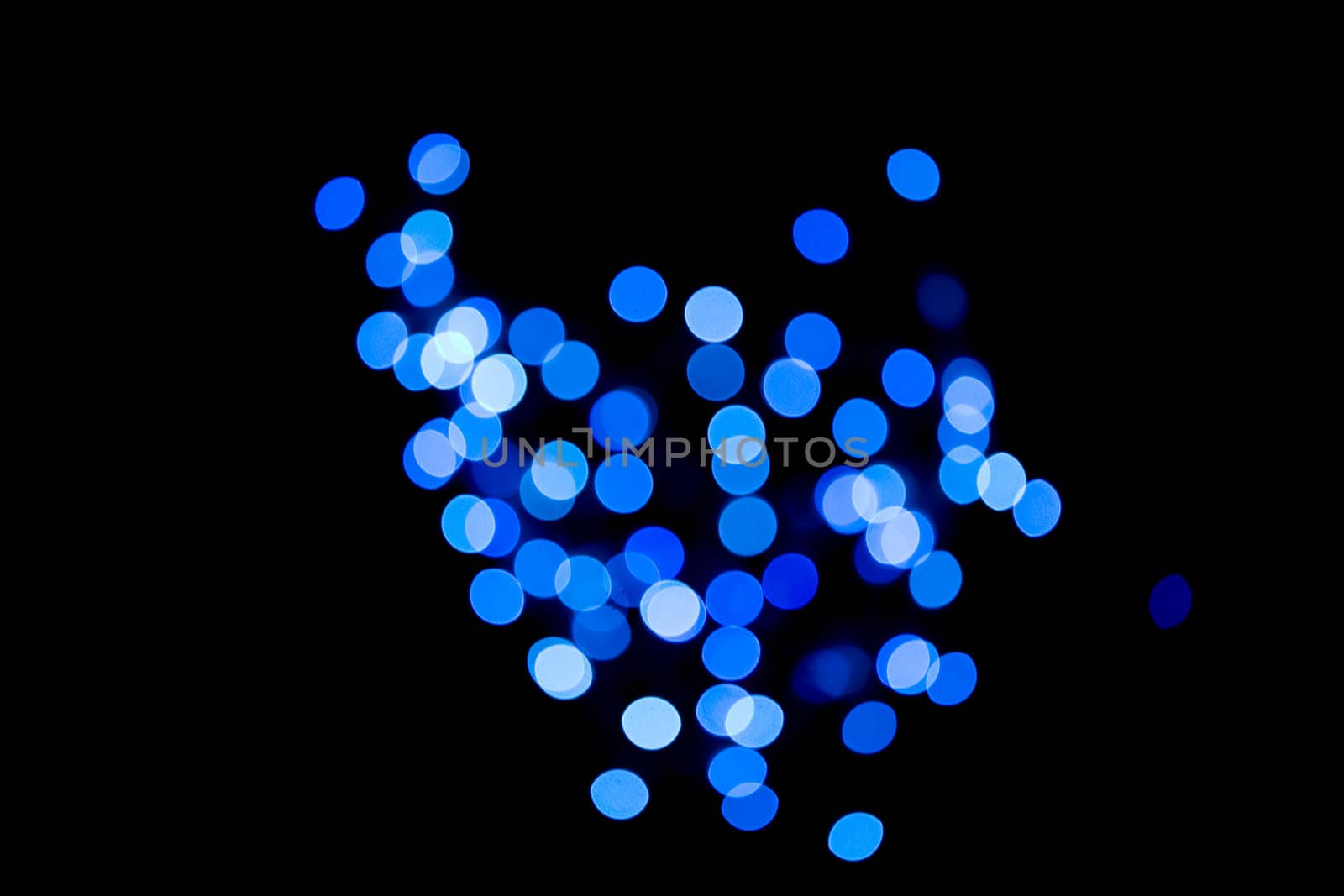 Blue defocused lights against black background