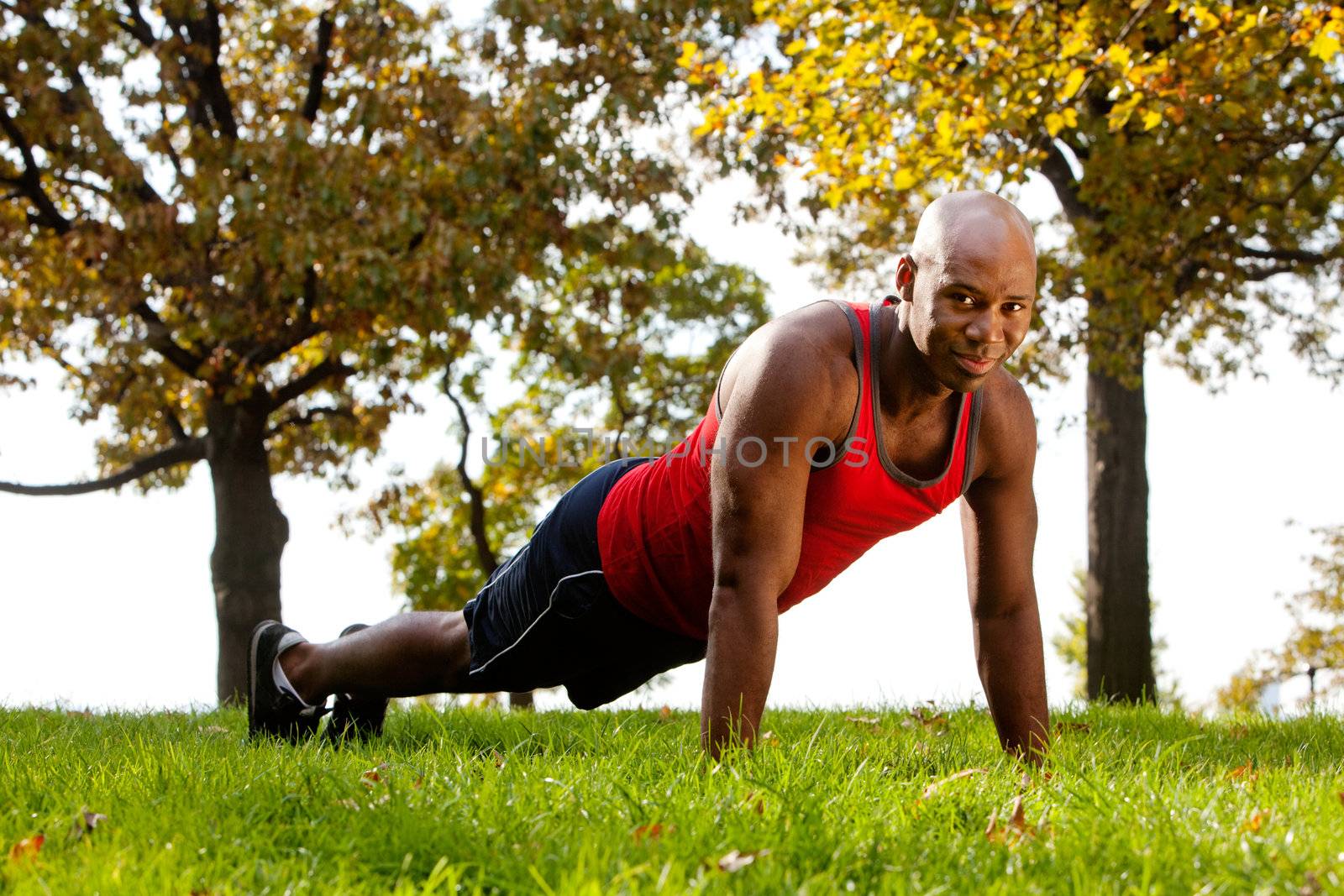 An african american doing exercises in the park