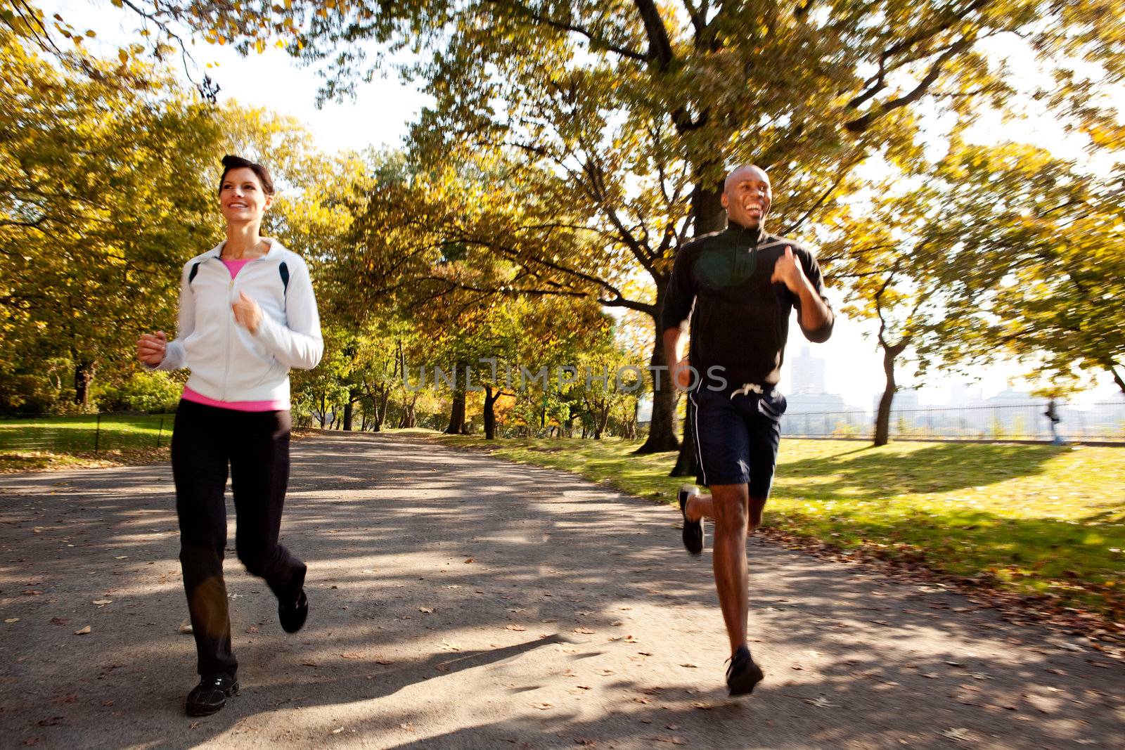 Two runners in a park with slight motion blur