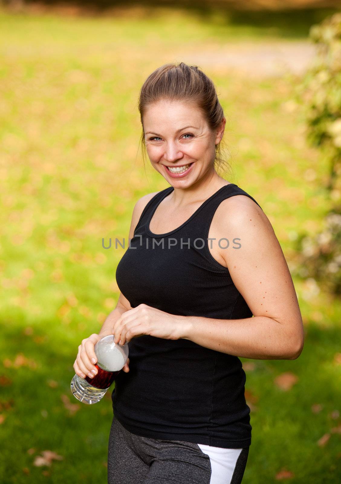 A woman taking a break from exercising in the park