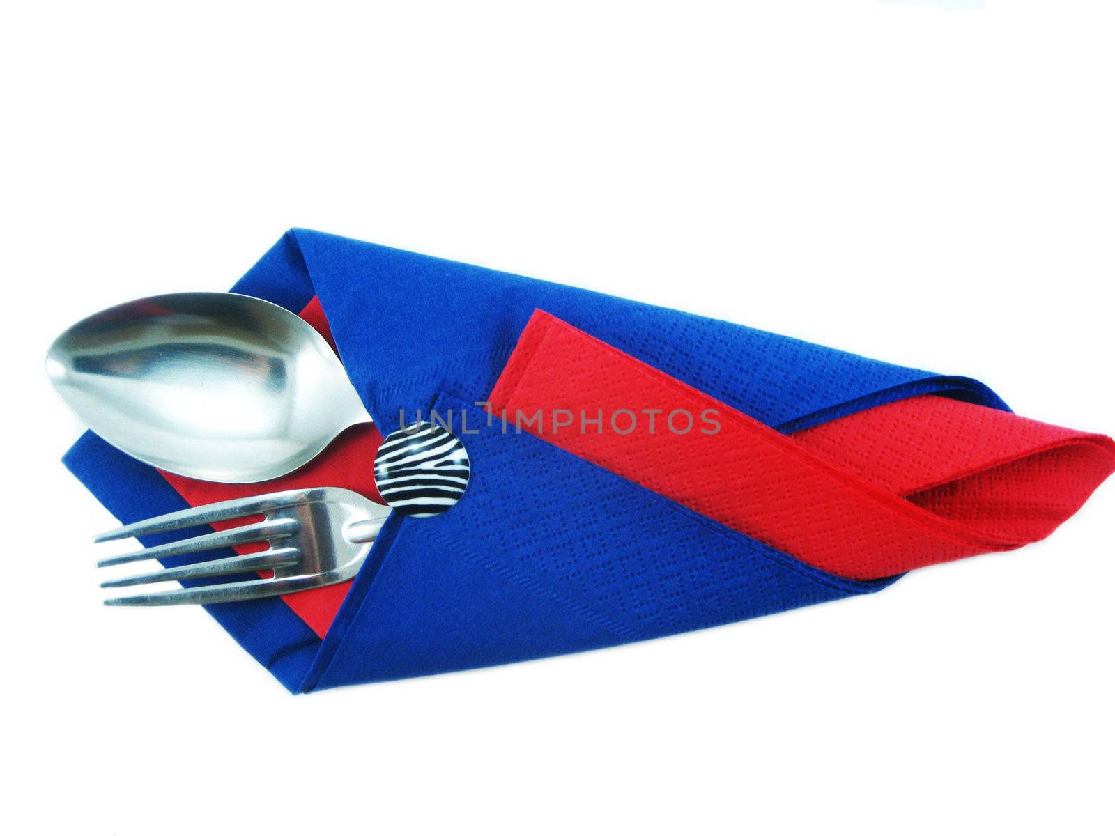Dining facilities, plug and spoon in a red and dark blue napkin

