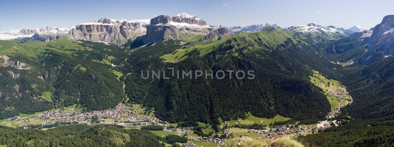 Aerial view of Canazei and Fassa valley with Saas Pordoi mount (Sella group), Pordoi pass and Fedaia pass