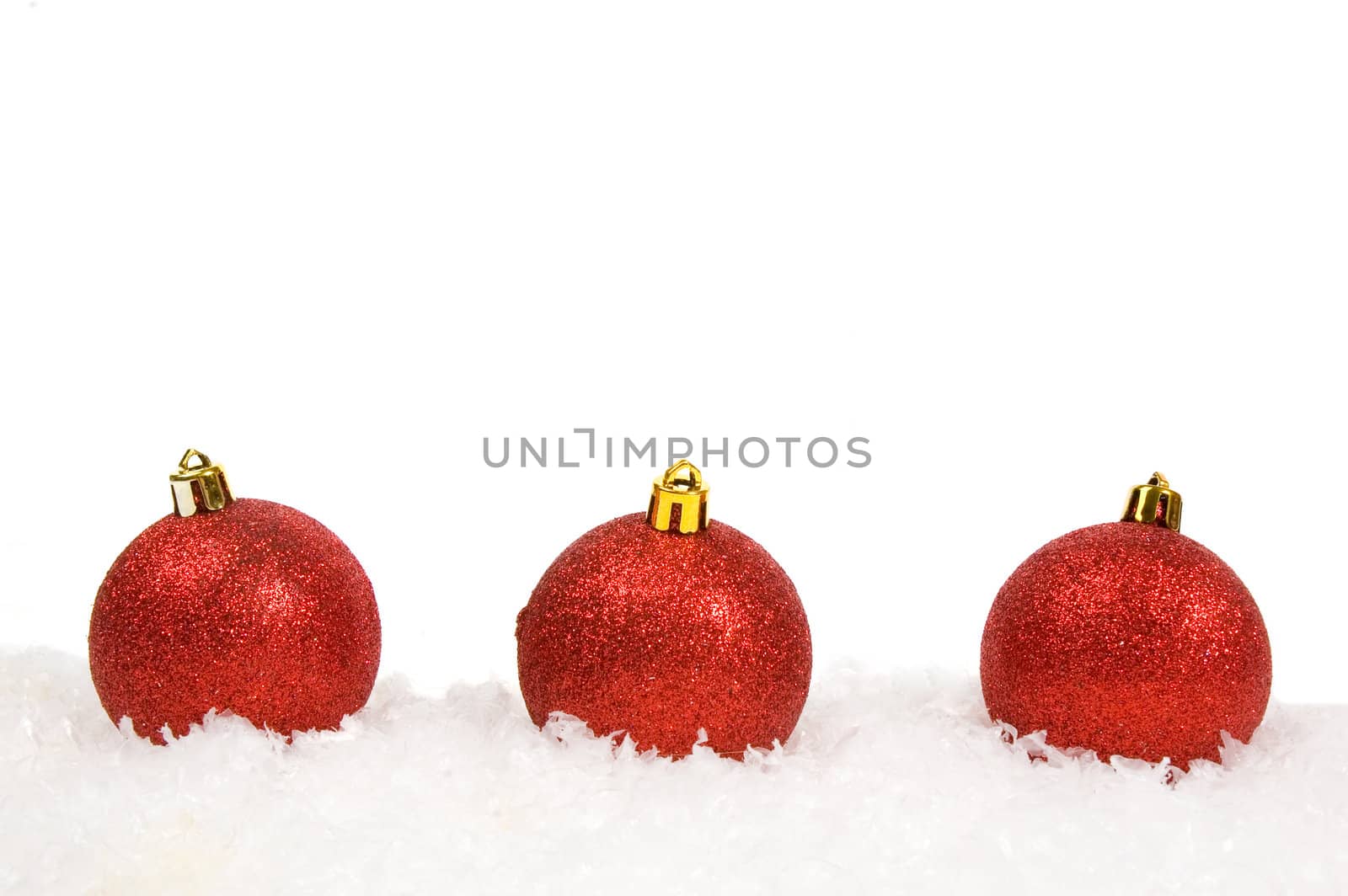 Red christmas balls with snow isolated on white  by ladyminnie