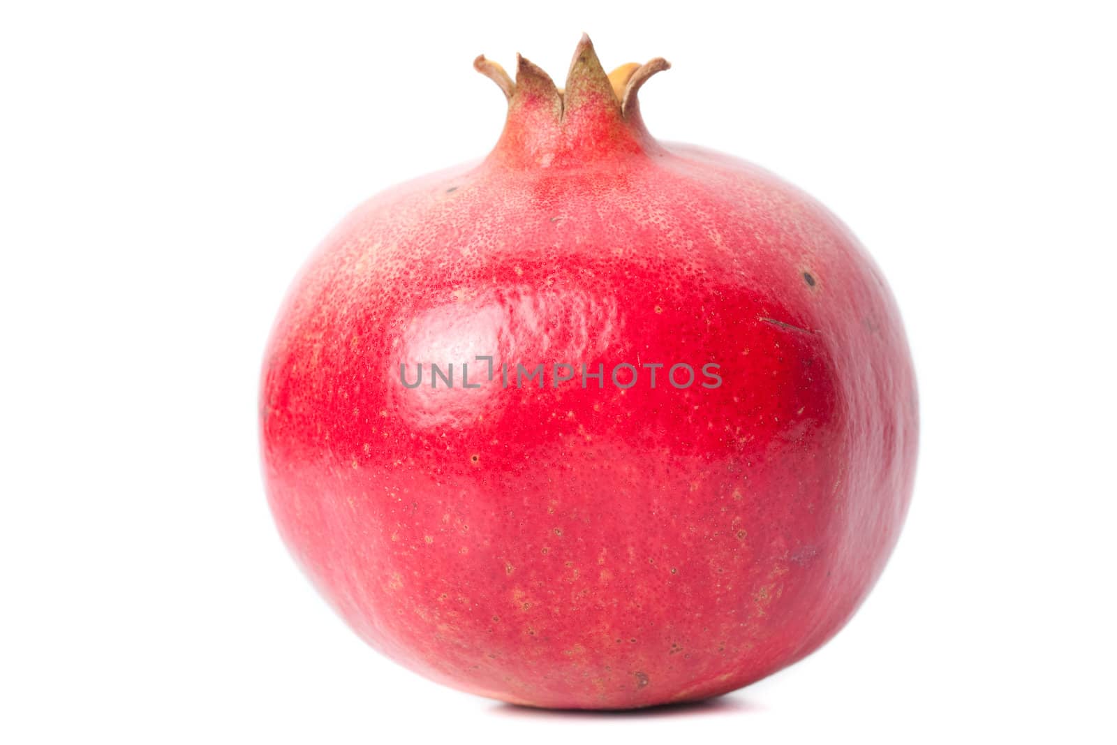 One whole ripe pomegranate fruit isolated on white background