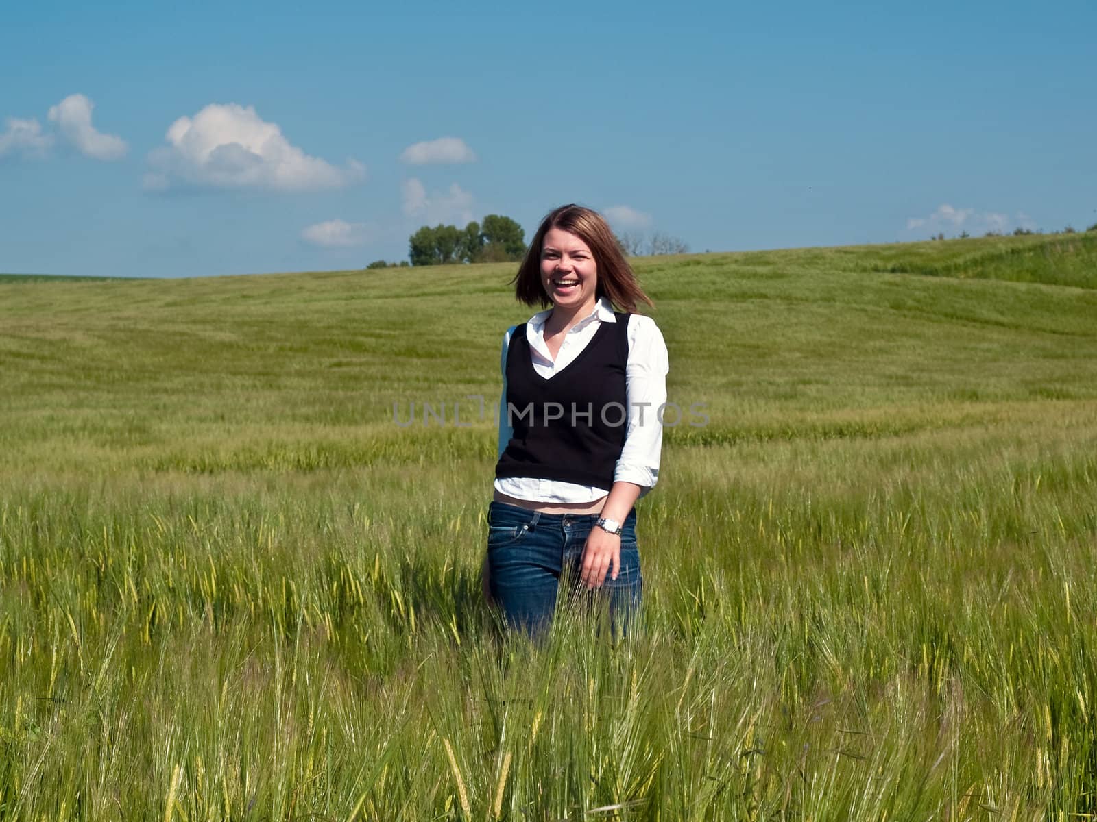 Beautiful attractive smiling young happy woman girl in a wheat field