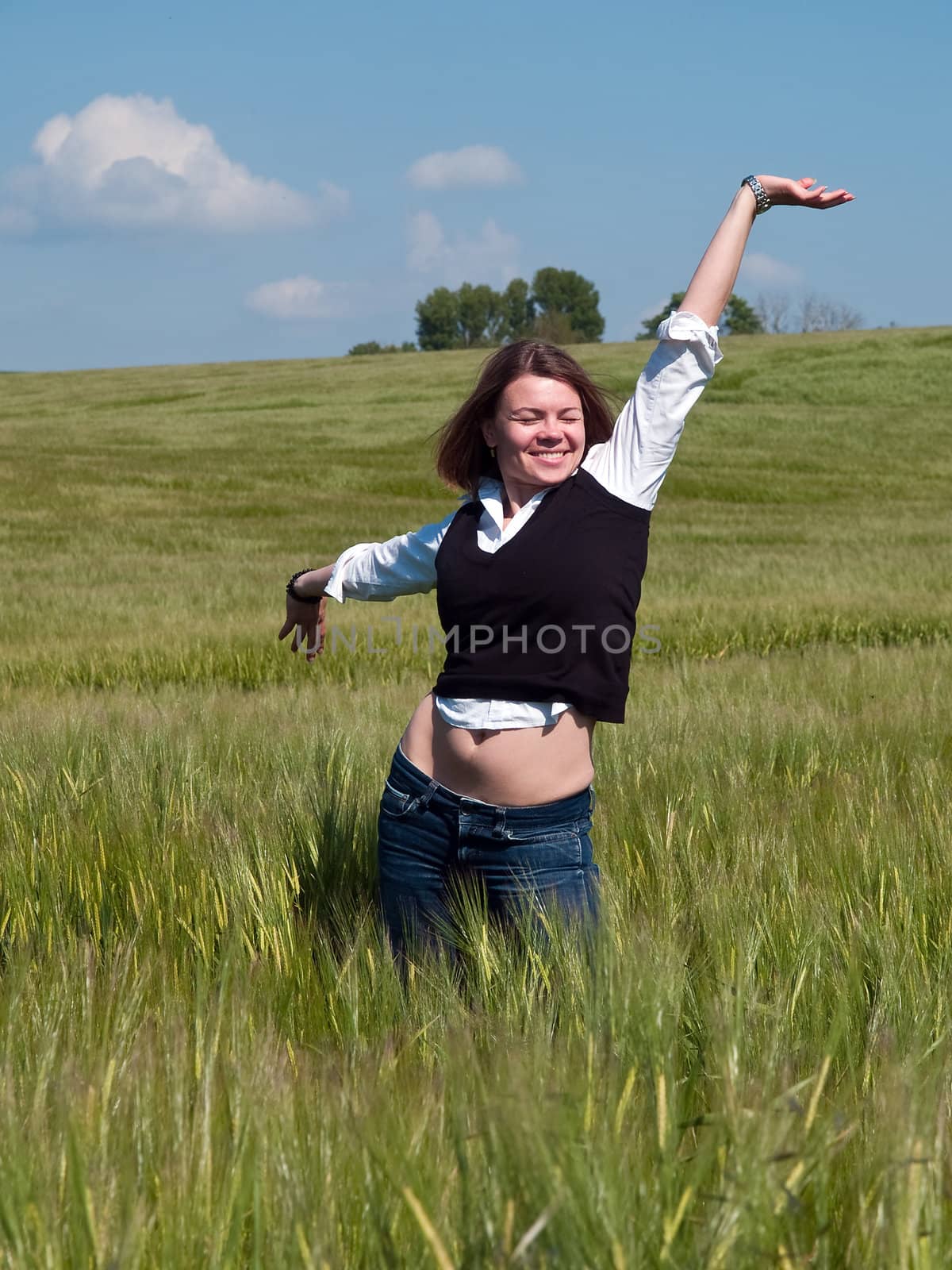 Beautiful attractive young happy woman in a wheat field by Ronyzmbow
