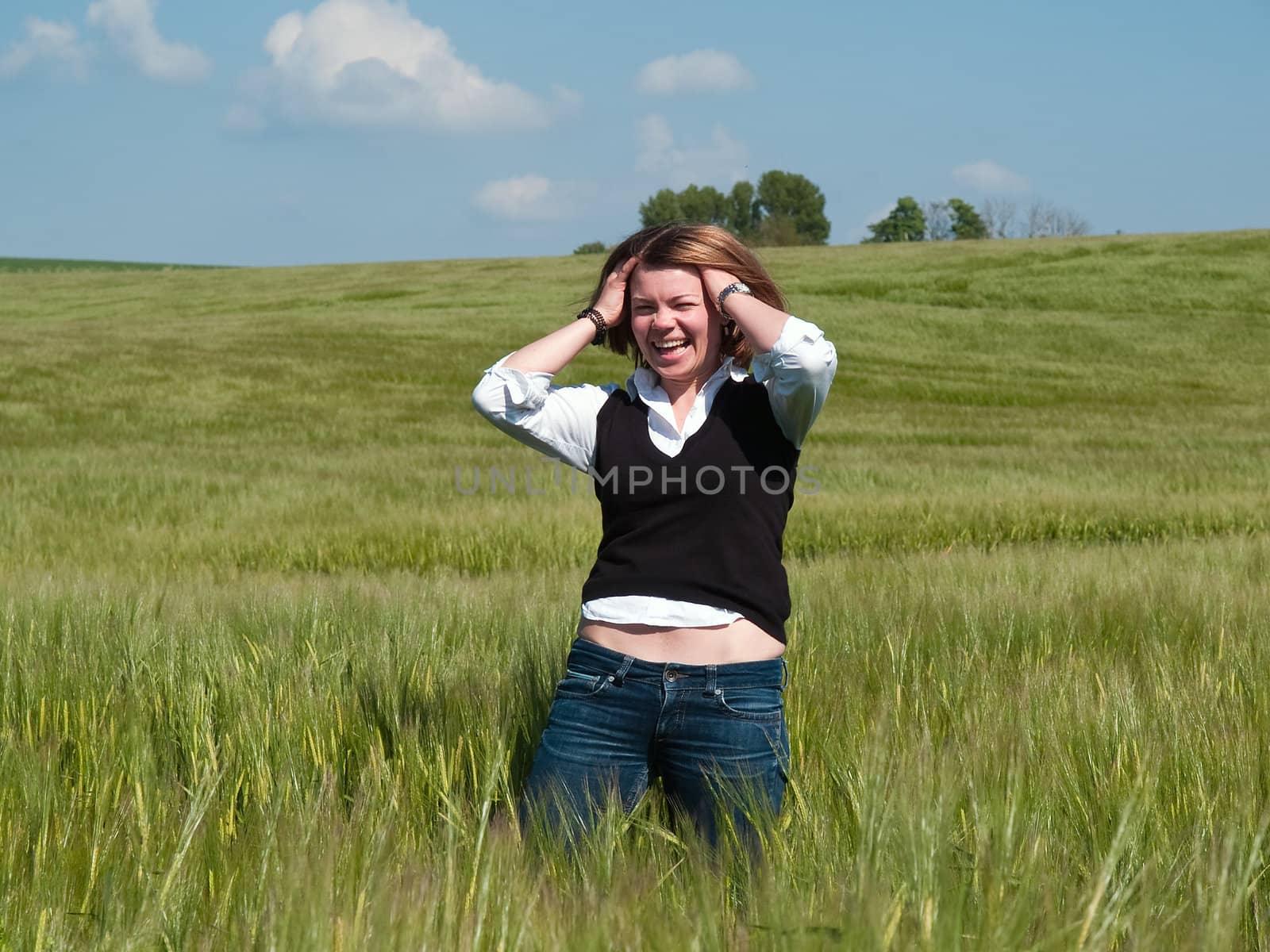 Beautiful attractive smiling young happy woman girl in a wheat field