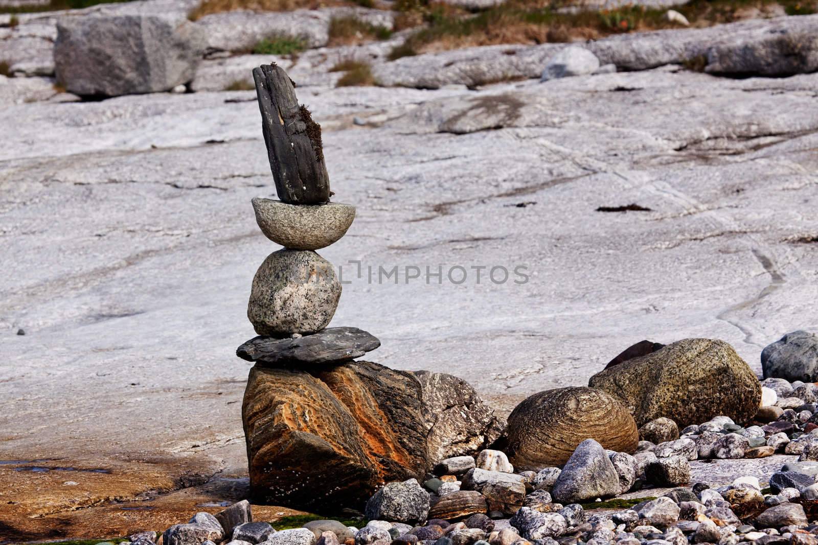 A rock stacking sculpture statue on a Norwegian landscape