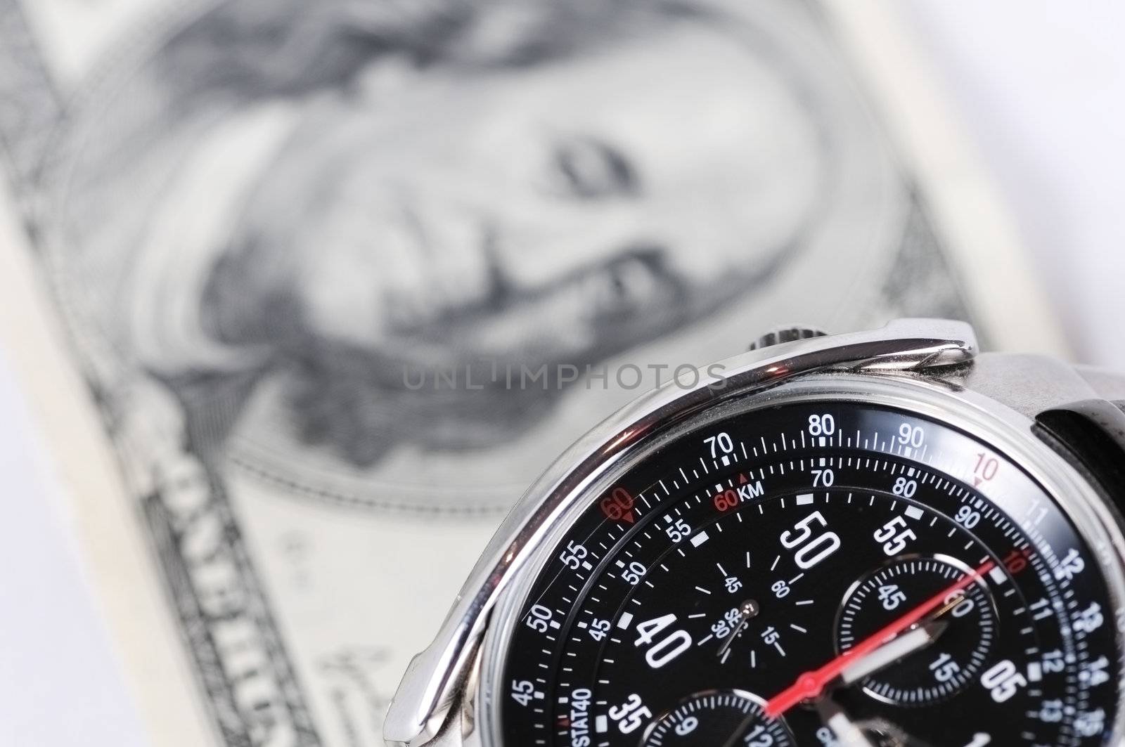 Photo of wrist watch shoot close up against hundred dollars