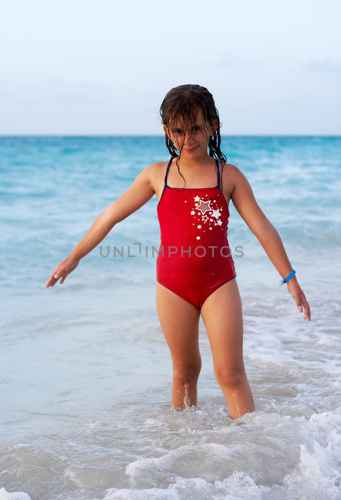 Beautiful caucasian  girl standing in the sea shore