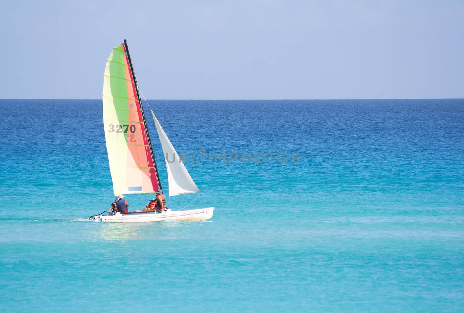 Small reacreational sailboat in a calm blue sea
