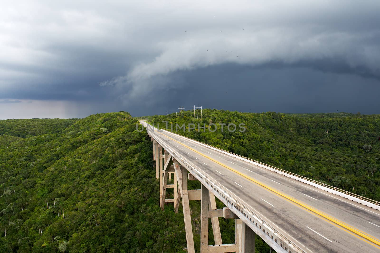 Tall bridge in a stormy weather with interesting clouds in the sky