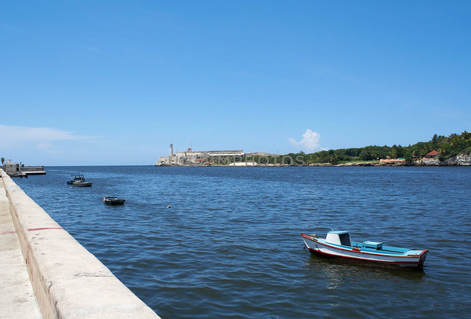 Fishing boats in the bay of Havana, Cuba wth the castle of El Morro in the background