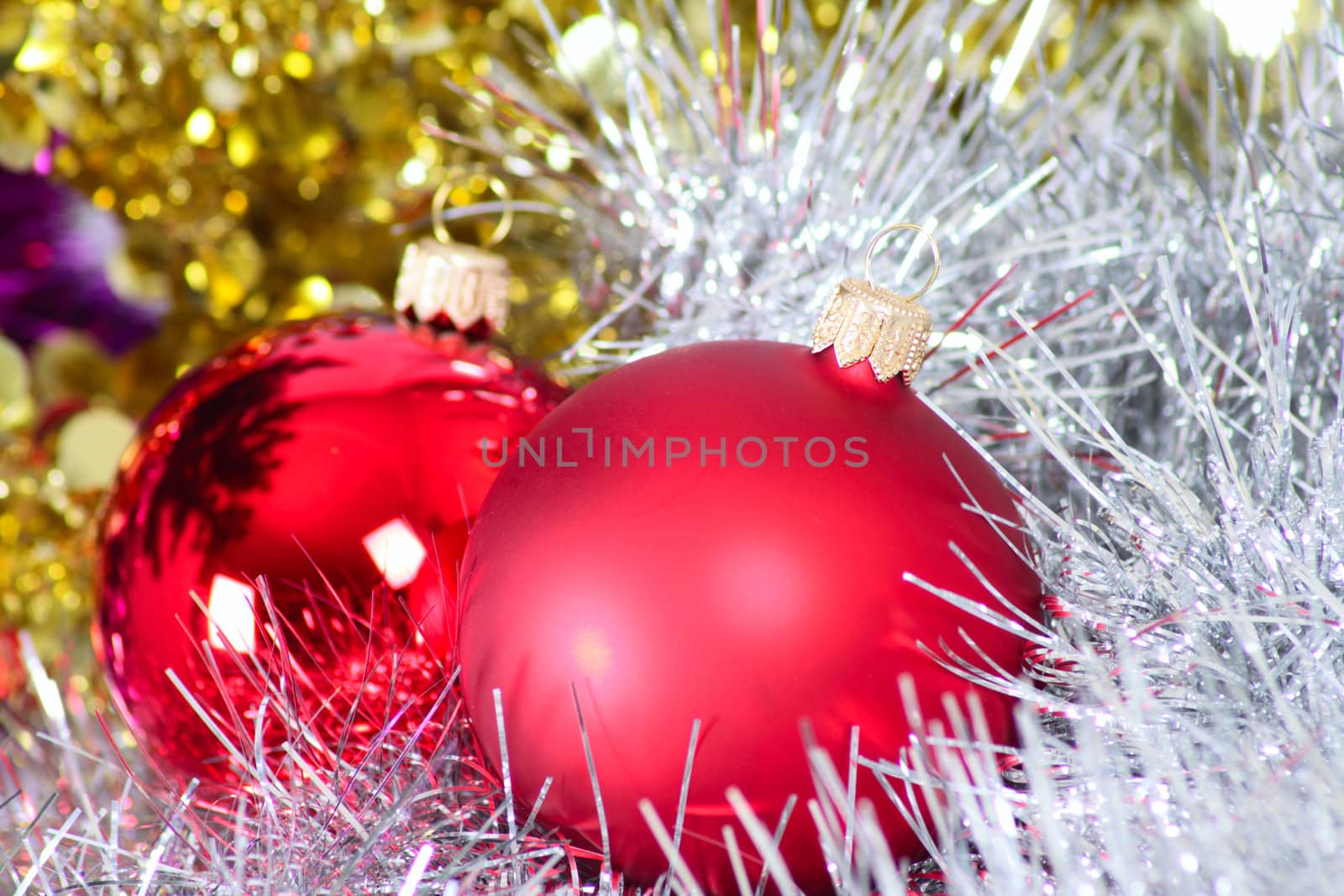 Two glass New Year's balls in a tinsel removed close up