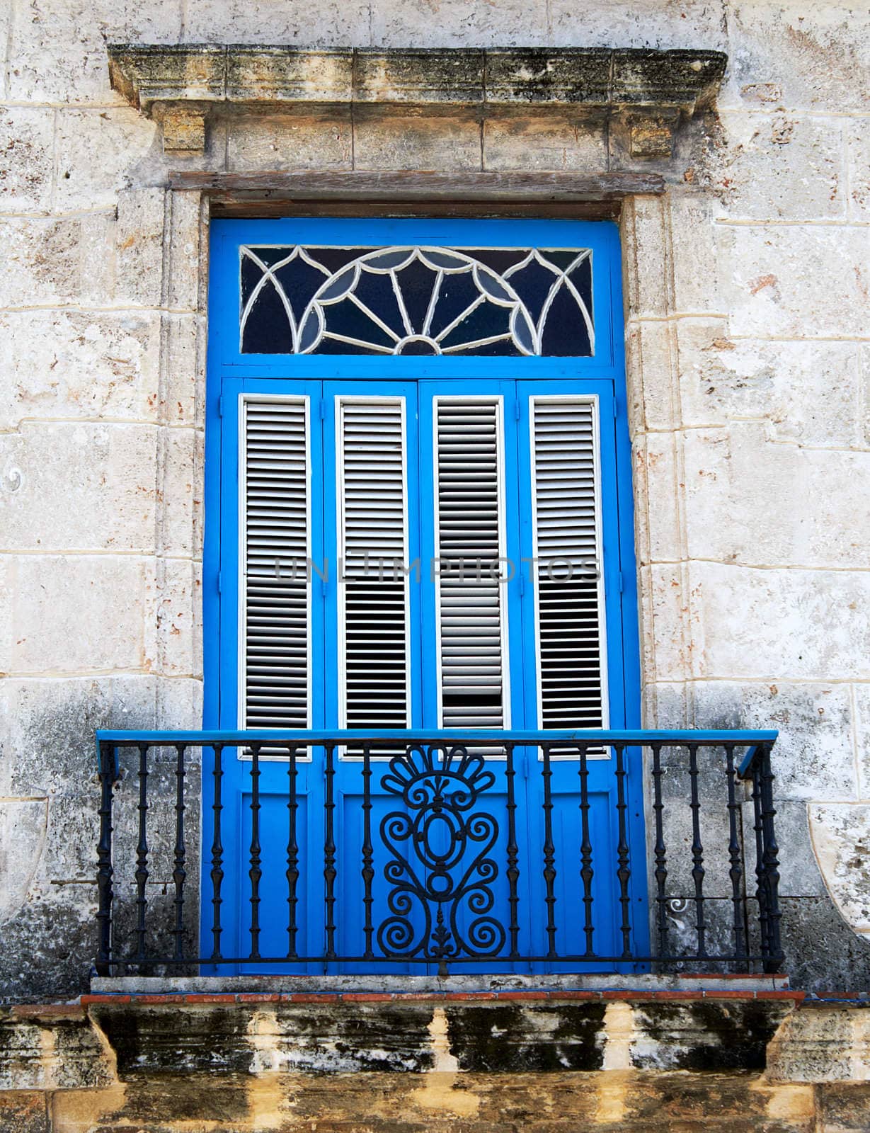 Old typical colonial balcony painted in vivid blue