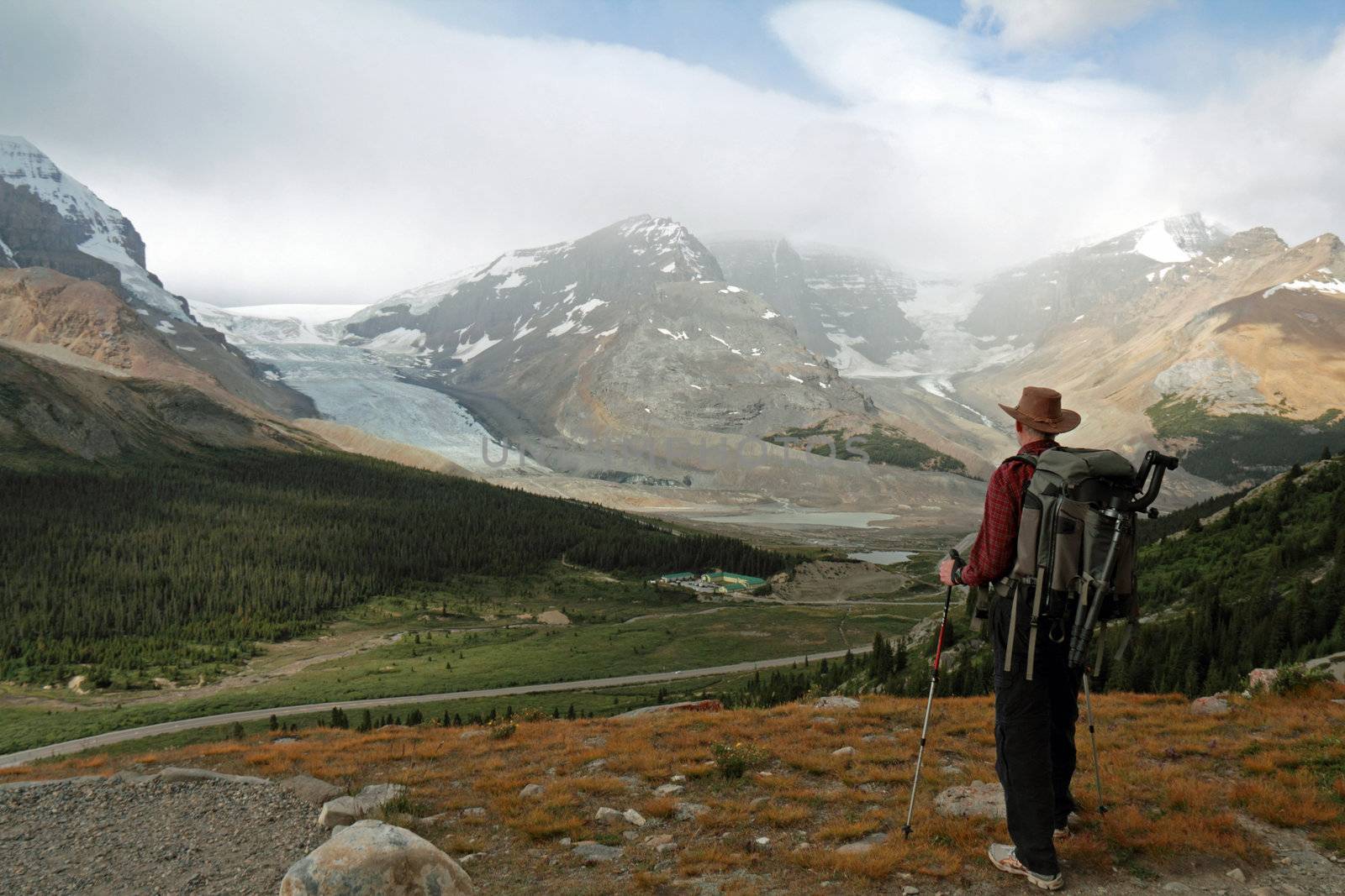 Hiker Looking Out Over Glaciers in the Rocky Mountains by gonepaddling