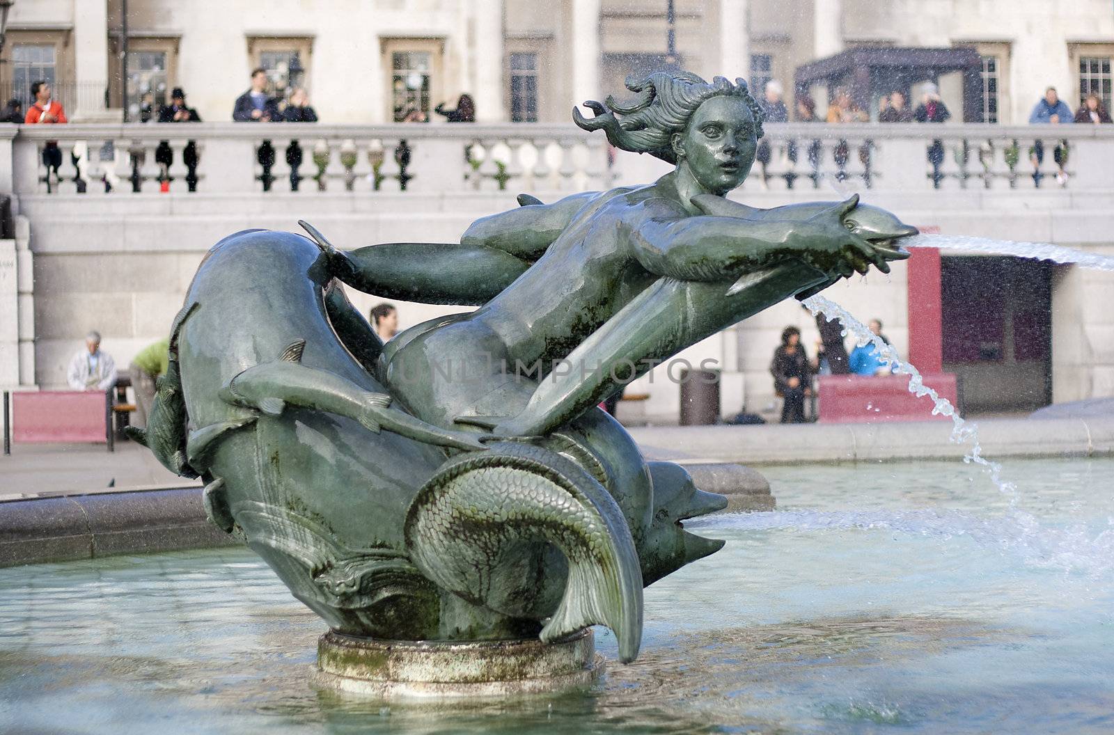 Fountain in Trafalgar Square in London representing a woman and dolphins