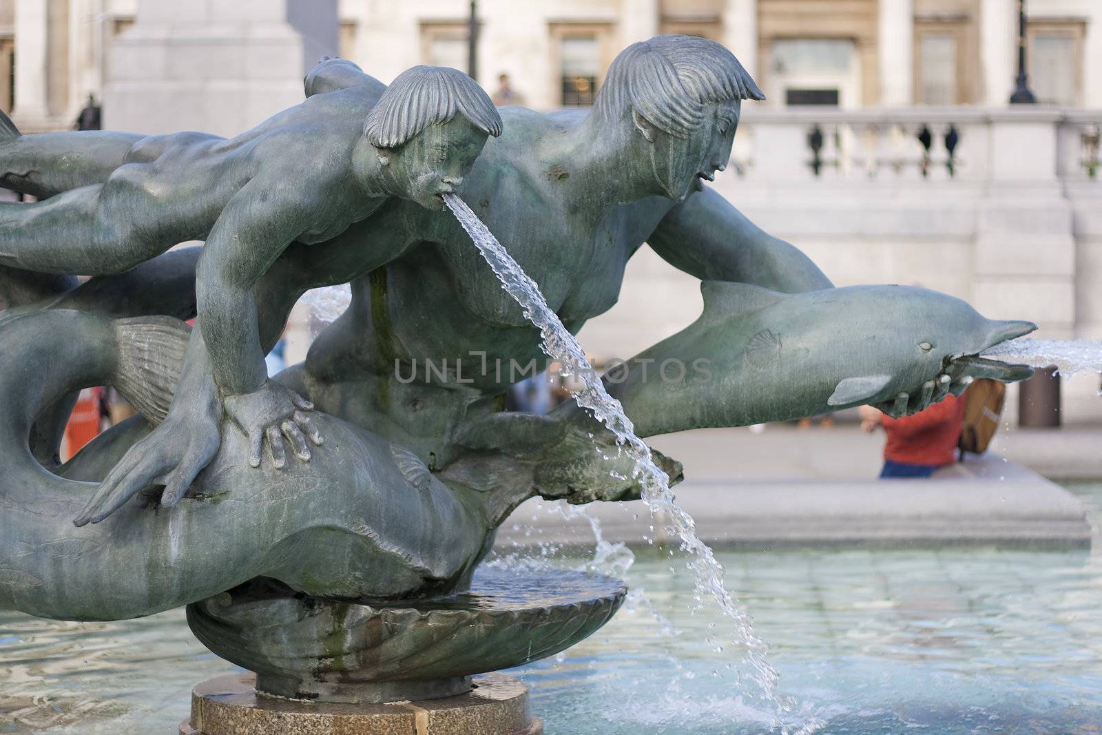 Fountain in Trafalgar Square in London representing people and dolphins