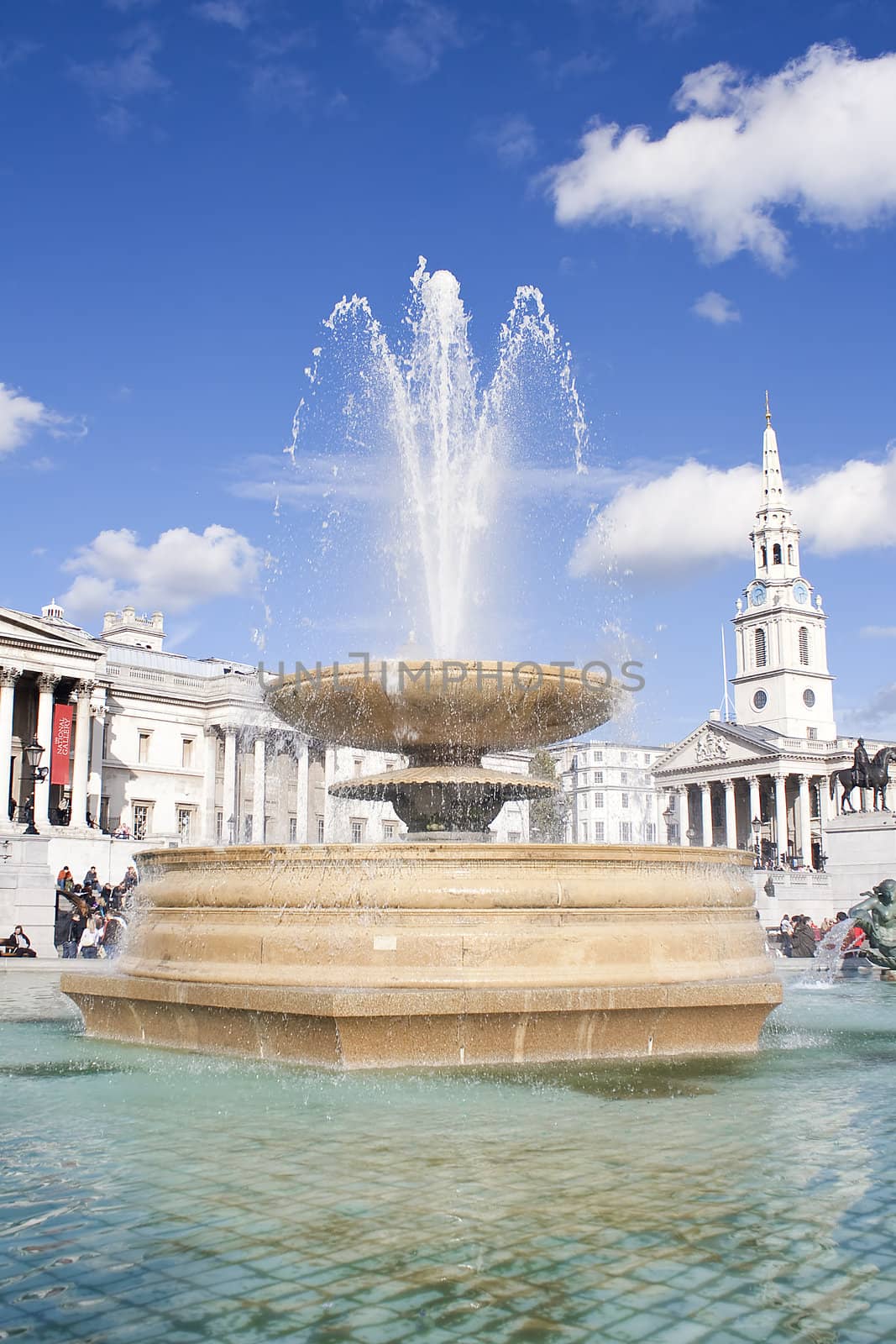 Fountain in Trafalgar Square in London by kmiragaya